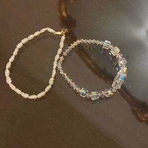 2 bracelets. One is fresh water pearl and the other is Crystal